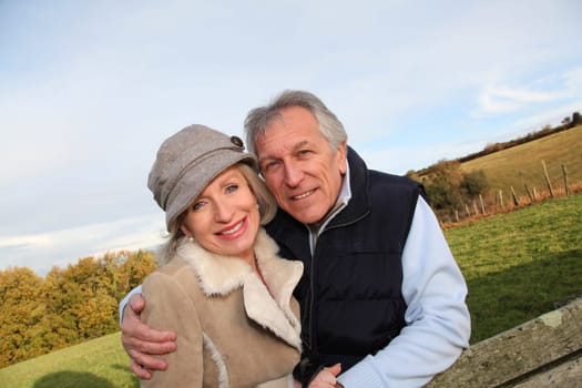 Happy senior couple embracing each other in countryside