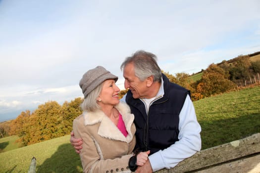 Happy senior couple embracing each other in countryside