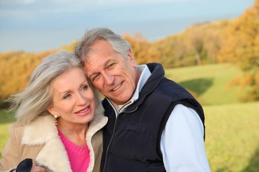 Happy senior couple embracing each other in countryside