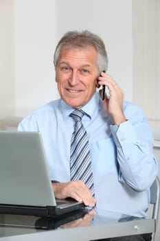 Portrait of senior businessman in office