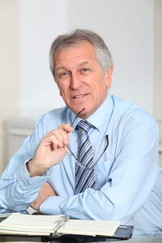 Portrait of senior businessman in office