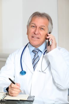 Closeup of doctor talking on the phone in the office