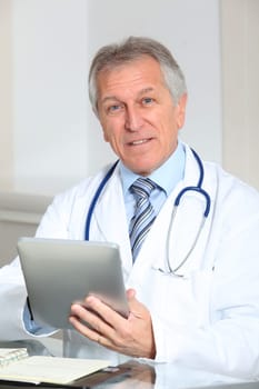 Closeup of doctor in the office with electronic pad