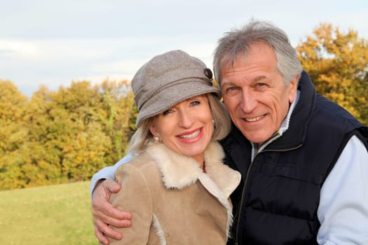 Happy senior couple embracing each other in countryside