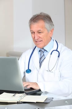 Closeup of doctor working on computer in the office
