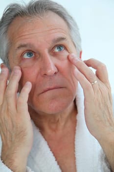 Senior man doing a face massage
