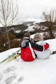 Senior couple at ski resortlooking at the mountain
