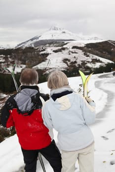 Senior couple at ski resortlooking at the mountain