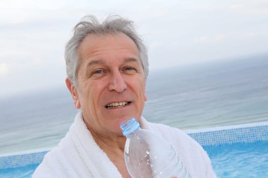Senior man dinking water from bottle