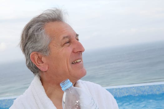 Senior man dinking water from bottle