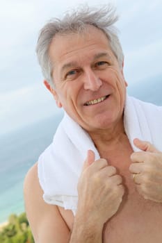 Portrait of senior man with towel aroung his neck