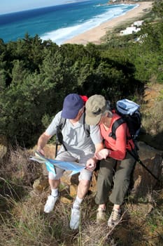 Senior couple looking at map on a rambling day