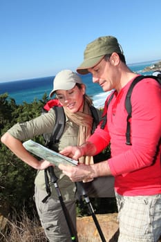 Couple looking at map on a hiking day