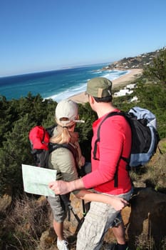 Couple looking at map on a hiking day