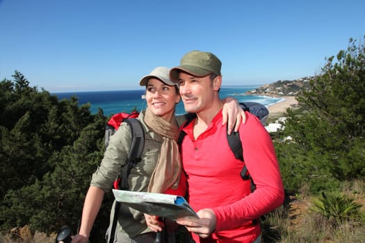 Couple looking at map on a hiking day