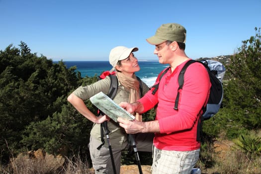 Couple looking at map on a hiking day