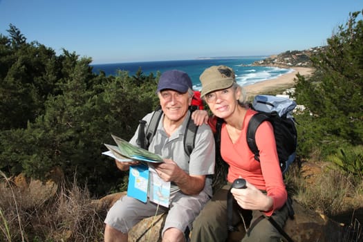 Senior couple looking at map on a rambling day