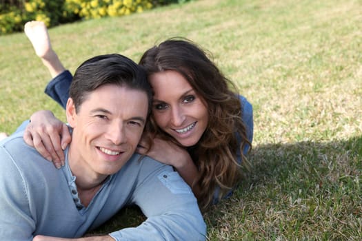 Couple relaxing in home garden