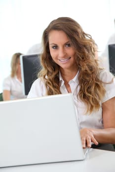 Smiling office worker in front of laptop computer
