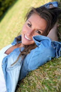 Beautiful woman laying down in the grass