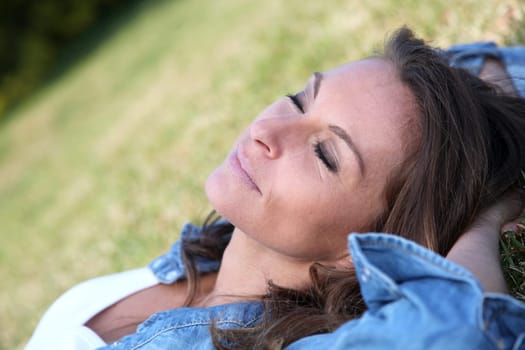 Beautiful woman laying down in the grass