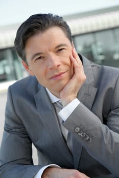 Portrait of businessman standing outside the office