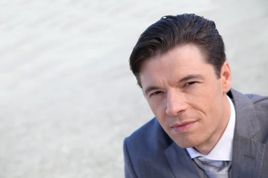 Portrait of businessman standing outside the office