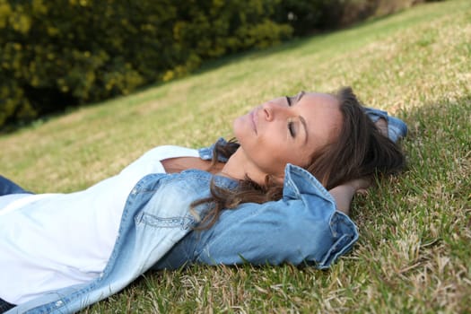 Beautiful woman laying down in the grass
