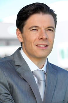 Portrait of businessman standing outside the office