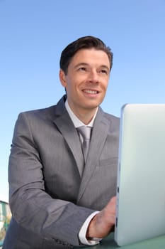 Portrait of businessman working on electronic tablet