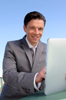 Portrait of businessman working on electronic tablet
