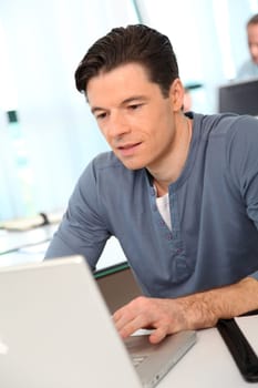 Portrait of office worker in front of laptop computer