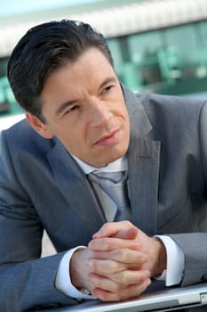 Portrait of businessman standing outside the office