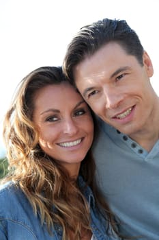 happy couple standing outside on a sunny day