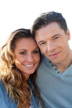 happy couple standing outside on a sunny day