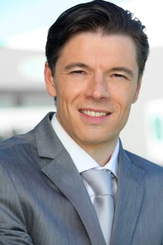 Portrait of businessman standing outside the office