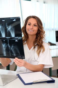 Nurse looking at X-ray in the office