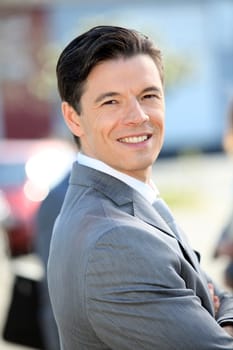 Portrait of businessman standing outside the office