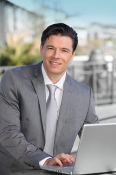 Portrait of businessman working on electronic tablet