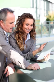 Business partners working on electronic tablet