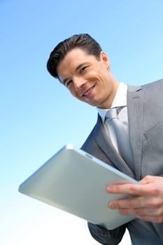 Portrait of businessman working on electronic tablet