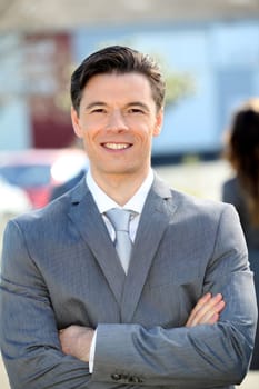 Portrait of businessman standing outside the office