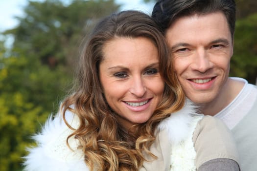 Portrait of smiling couple sitting outside on a sunny day
