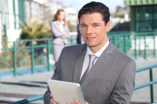 Portrait of businessman working on electronic tablet