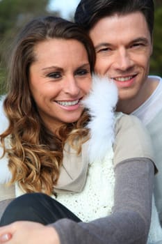 Portrait of smiling couple sitting outside on a sunny day