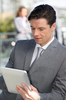 Portrait of businessman working on electronic tablet