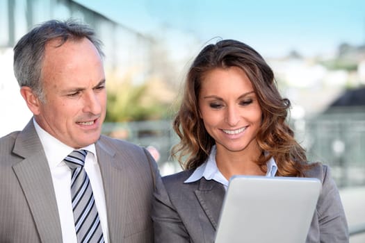 Business partners working on electronic tablet