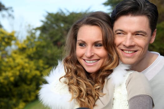 Portrait of smiling couple sitting outside on a sunny day