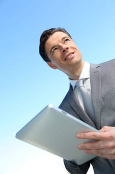 Portrait of businessman working on electronic tablet