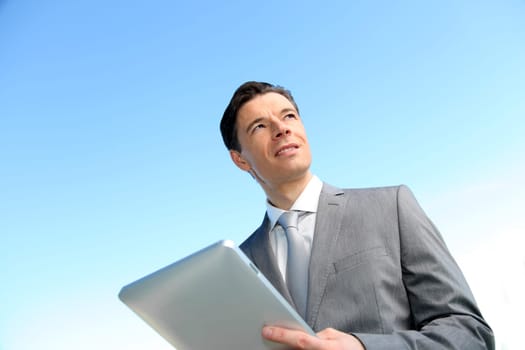 Portrait of businessman working on electronic tablet